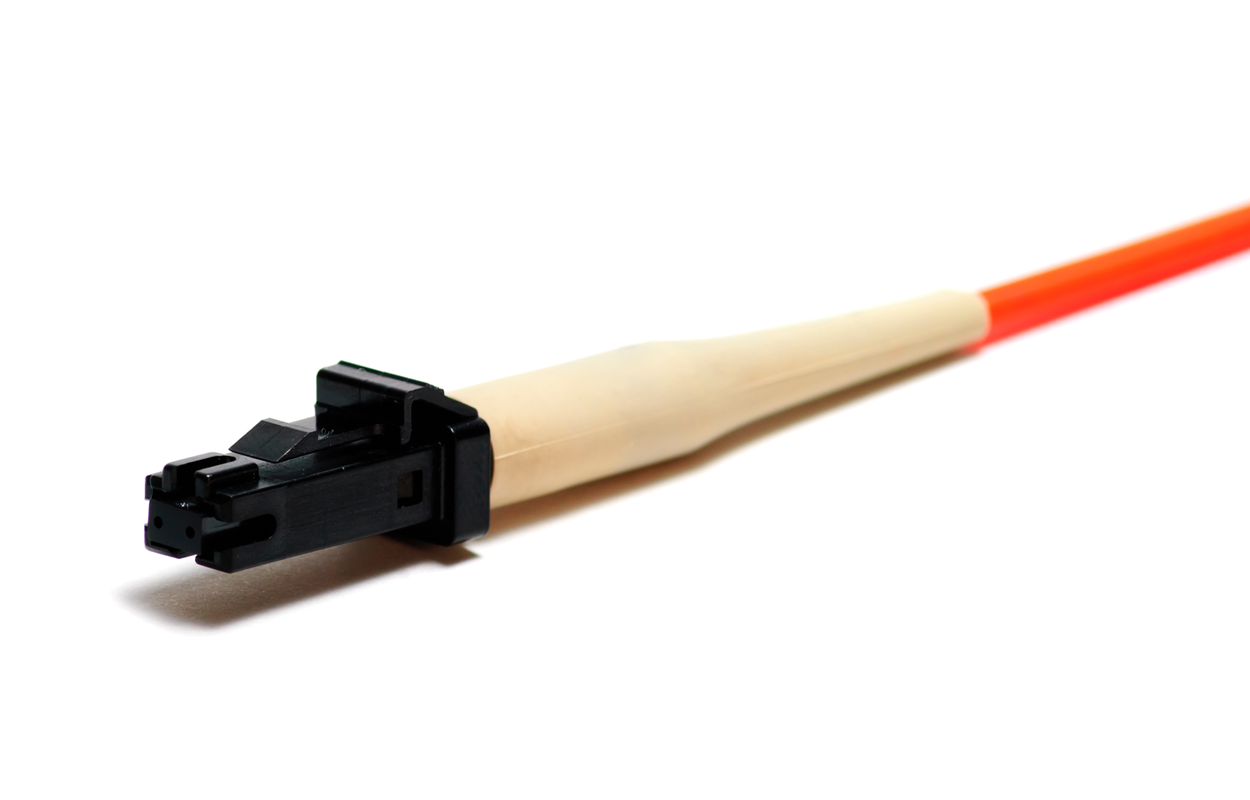 An MT–RJ fiber optic connector. The connector body is plastic with a rectangular push-pull-style interface. An orange fiber cable extends from the back, and a tapered strain relief boot covers the cable where it meets the connector.