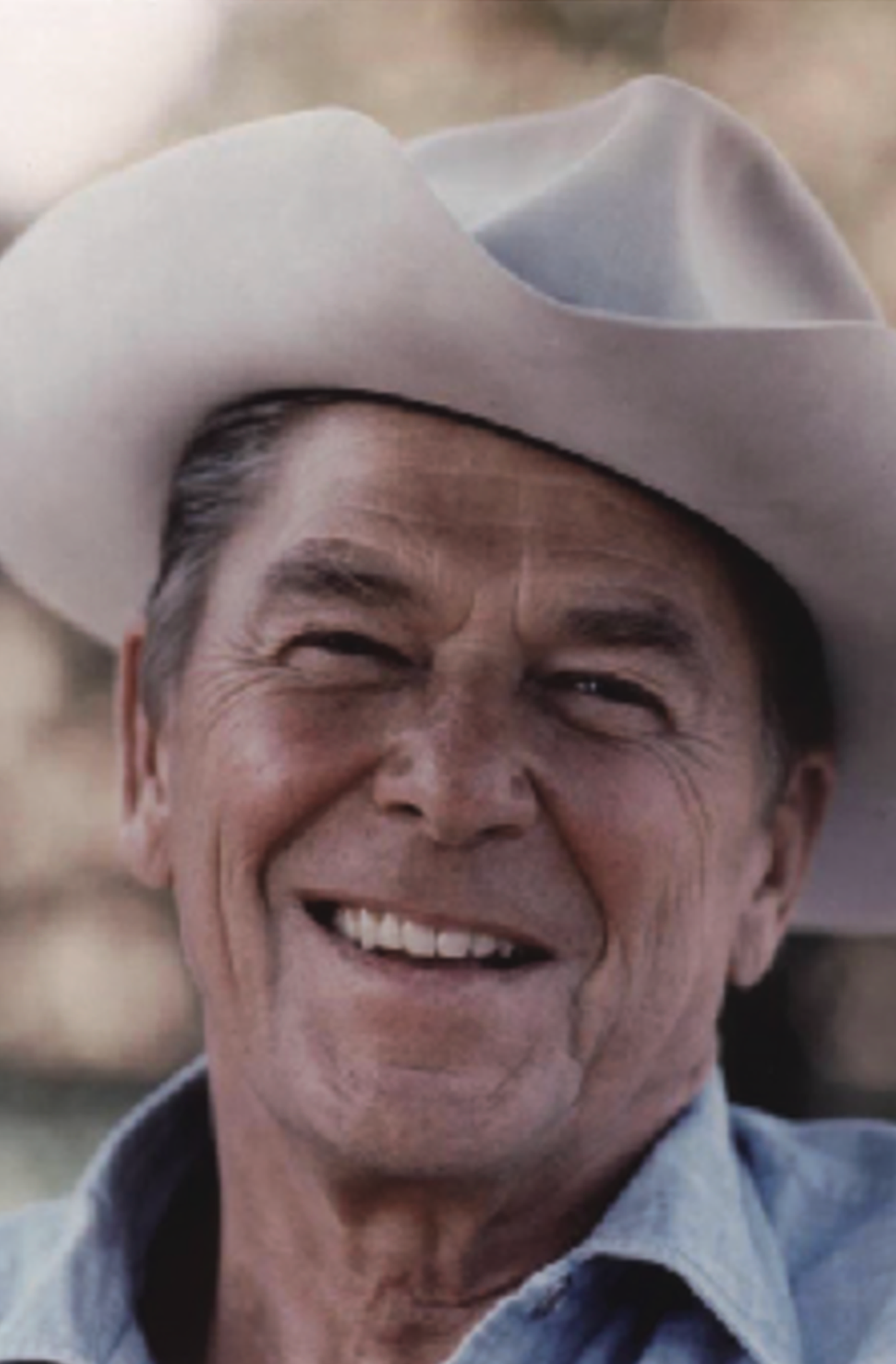 A photo of President Reagan with a cowboy hat.