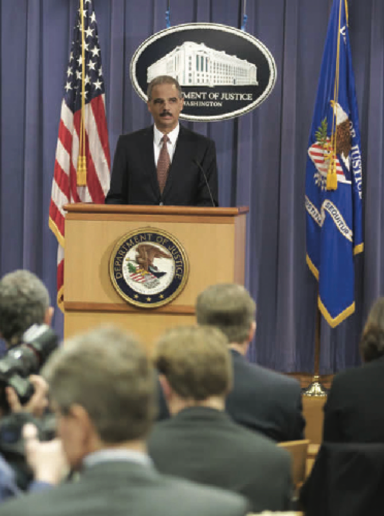 Attorney General Holder at a podium.
