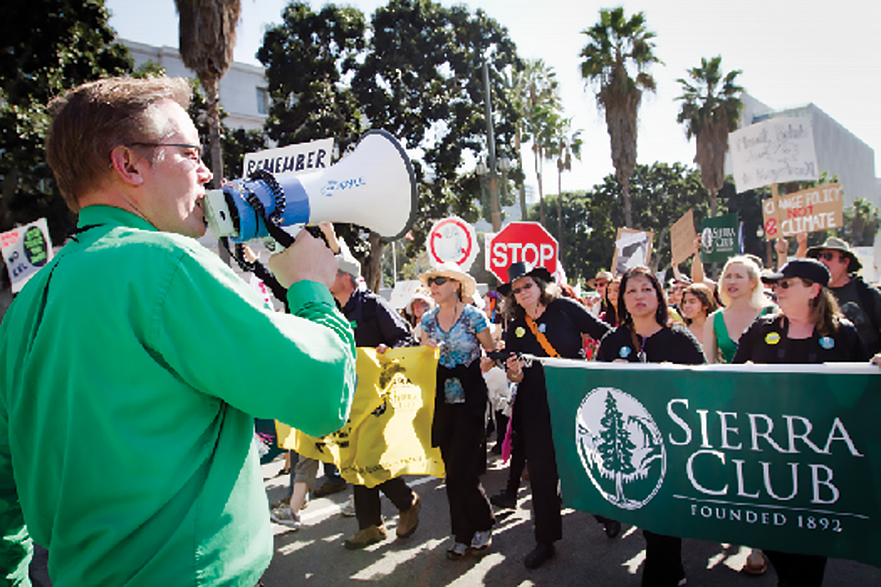 A person with a megaphone speaking to a crowd
