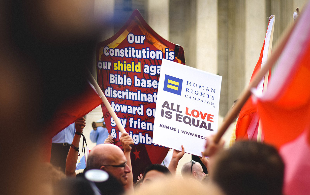 A photo of many signs held by people in a protest.