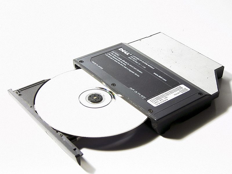 a Dell C D, D V D Rom drive and disk that has been removed from a computer
