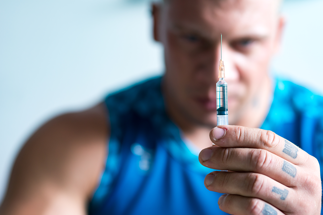 A Bodybuilder Preparing to Inject Anabolic Steroids