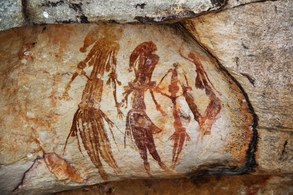 group of stylized animals drawn on the side of cave wall