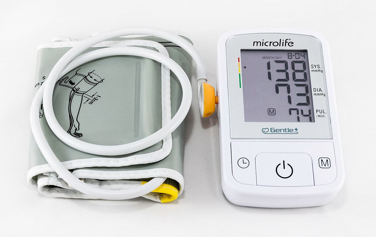 A photo shows a blood pressure cuff connected to a device with an electronic display reading 8-04, 138 SYS mm Hg, 73 DIA mm Hg, 74 PUL.